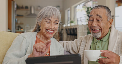 Buy stock photo Tablet, laughing and senior couple on couch with retirement meme and streaming comedy film in home. Interracial marriage, elderly man and woman with tech on sofa for funny gif and reading silly story