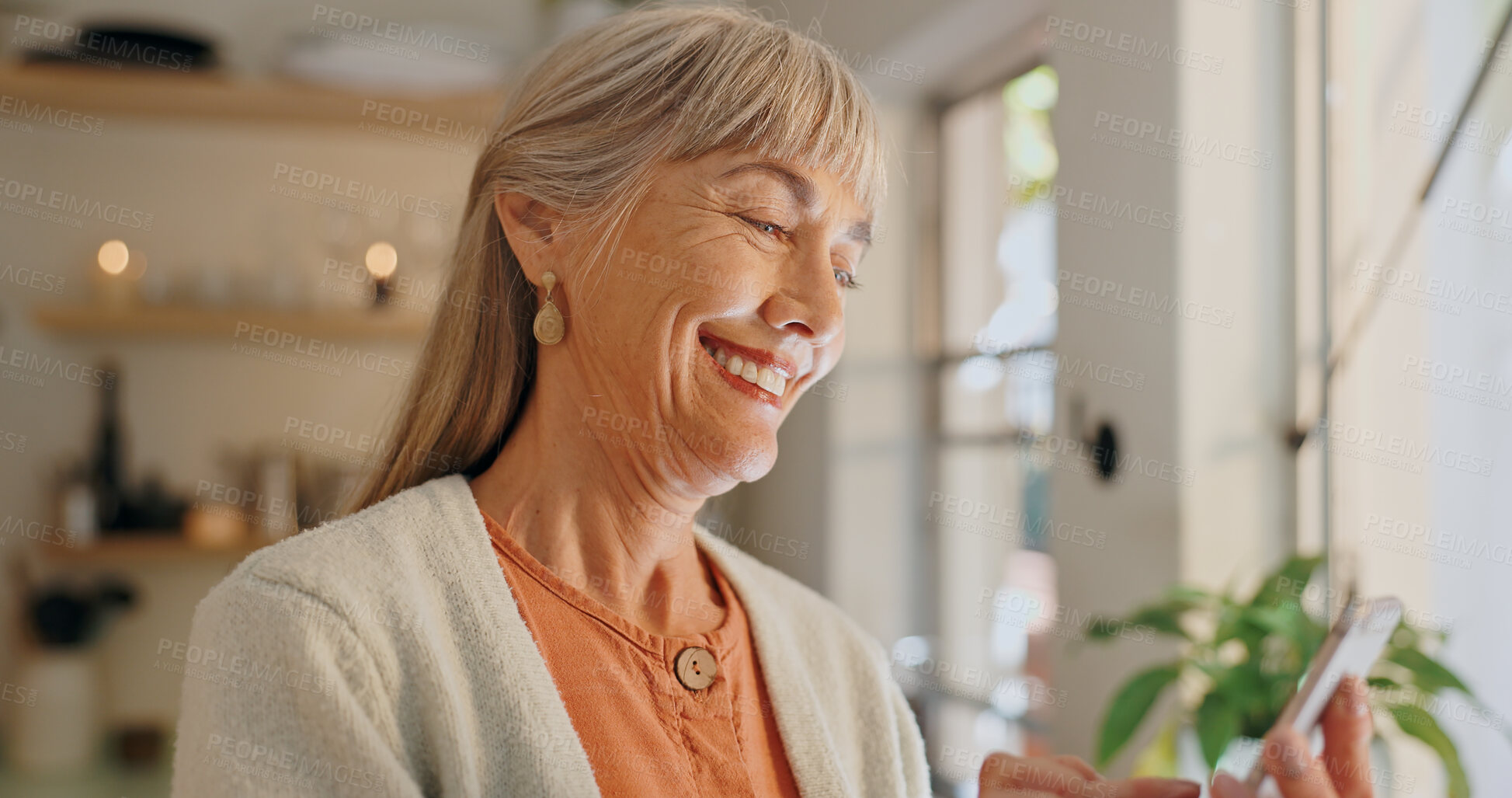 Buy stock photo Senior woman, phone and app for internet message in home, reading notification and scroll on blog. Elderly person, typing and text for communication, smile and conversation for funny joke or laugh