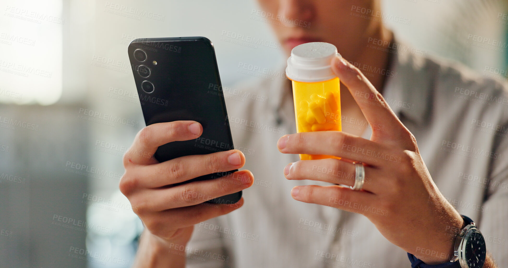 Buy stock photo Home, pills and hands of man with phone for internet research, medical app and reading medication label. Male person, prescription drugs and mobile with healthcare website for online faq and warning