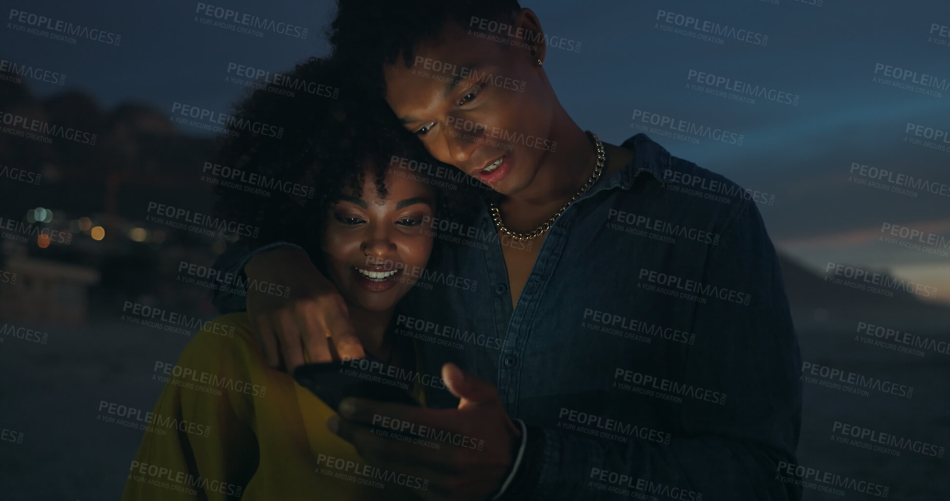 Buy stock photo Couple, together and night in nature with smartphone, romance and social media on beach. Man, happy woman and scroll on phone for memories, updates and browsing website for blog post in evening