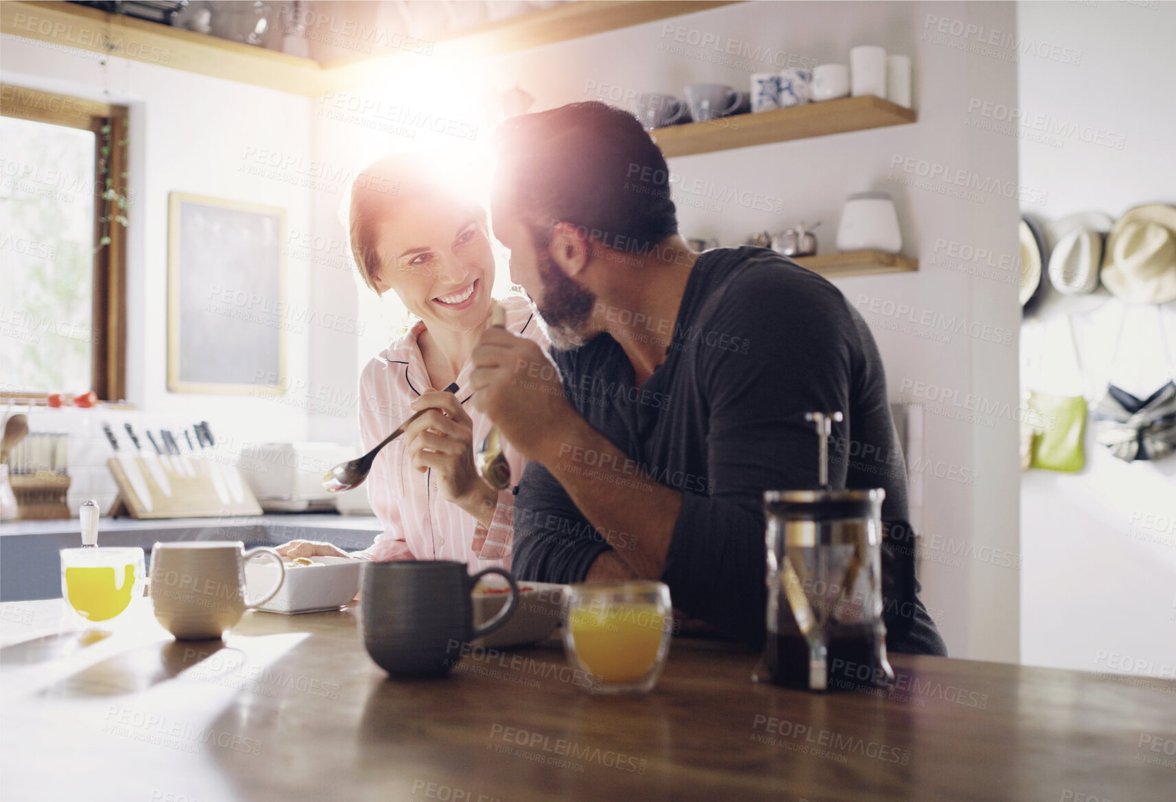 Buy stock photo Couple, breakfast or eating cereal together at table with love, care or juice for fiber in meal in home. Romantic people, smile and healthy snack for bonding, nutrition and food in happy marriage