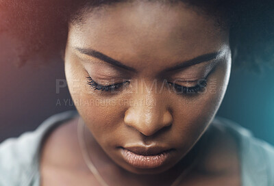 Buy stock photo Mental health, sad and black woman in studio with depression, anxiety and disappointed with stress. Girl person, head down and unhappy on dark background with closeup, serious and thinking of crisis.