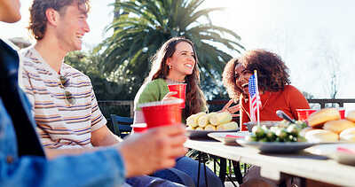 Buy stock photo Friends, group and independence day outdoor with food, drinks and talking of happy international holiday. Young and social people excited for fourth of July with American Flag, lunch and patio table