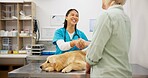 Woman, vet and dog at clinic with shaking hands, care and deal for health, wellness and happy for introduction. People, doctor and golden retriever pet with check, exam and help at animal hospital