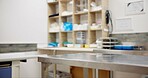 Vet, room and table with equipment for clinic, shelter or storage of tools and medication at animal hospital. Empty space, interior or surface for pet visit, examination or checkup center in facility