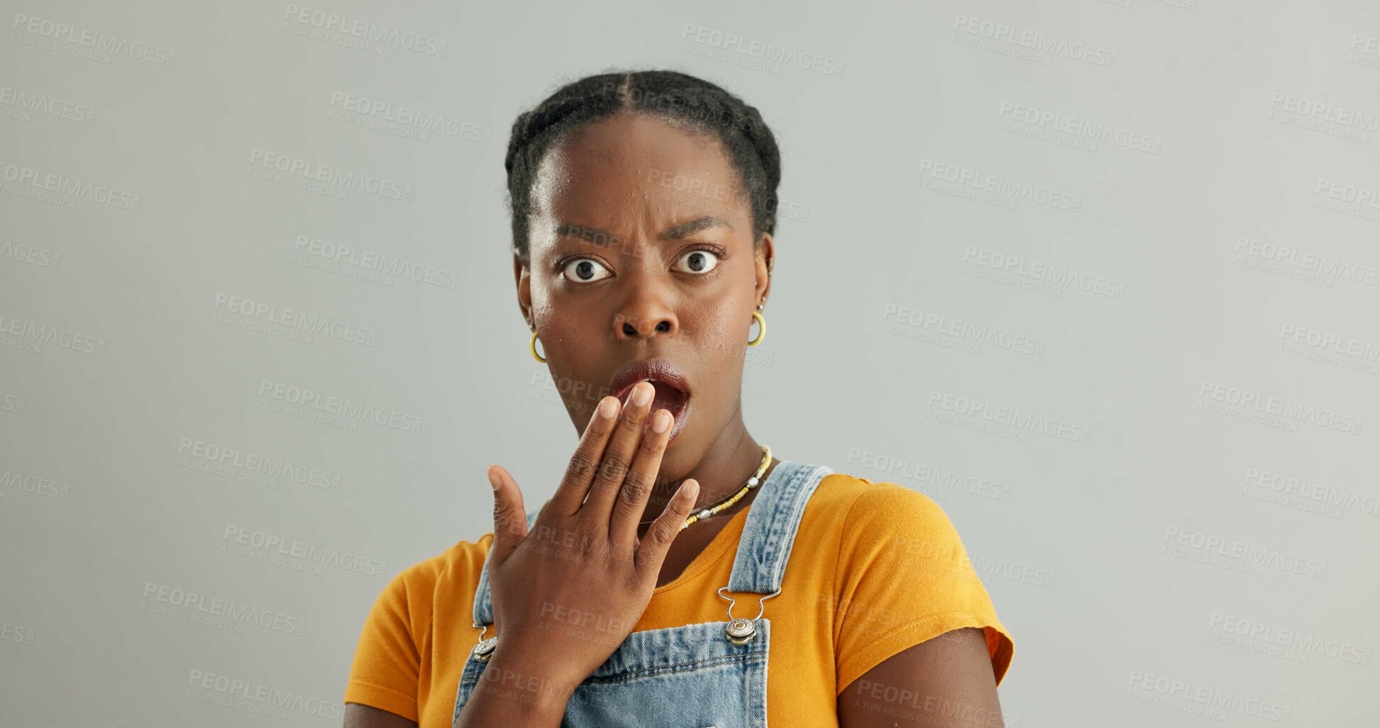 Buy stock photo Shocked, portrait and black woman in studio with omg for announcement, gossip or fake news on gray background. Wtf, mockup and person with hand covering mouth for secret, wow or unexpected revelation