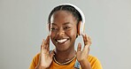 African woman, headphones and happy in studio for streaming, listening or audio by white background. Girl, person and student with smile with sound, subscription or online radio for music with memory