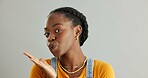 Black woman, portrait and hand kiss in studio for flirting love, romance and care emoji with support of aesthetic date. African, female person and air lips for kindness, pride and white background