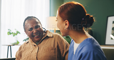 Buy stock photo Senior, woman and caregiver with talking or laughing on sofa in nursing home for support, funny story and kindness. Elderly person, nurse and happy in hospice with compassion, understanding and joke