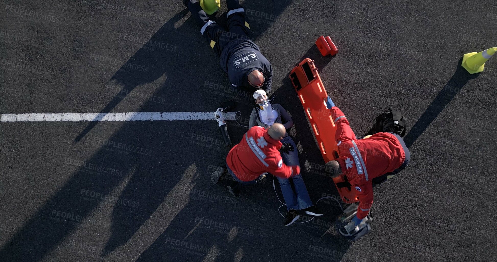 Buy stock photo Accident, emergency and first aid with paramedic team on street from above for medical treatment. Healthcare, medicine and group of EMT people on road with patient for assessment, CPR or response