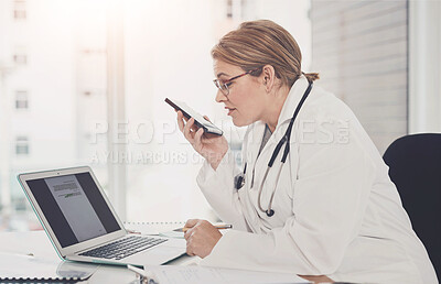 Buy stock photo Cropped shot of an attractive young female doctor taking a phonecall while working in her office