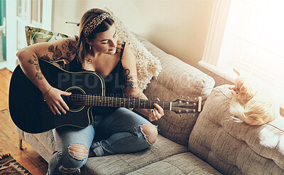 Buy stock photo Woman, dog and playing a guitar on sofa for music practice, learning chords and rehearsal for performance in home. Musician, artist and person with strumming strings on instrument for audio tuning