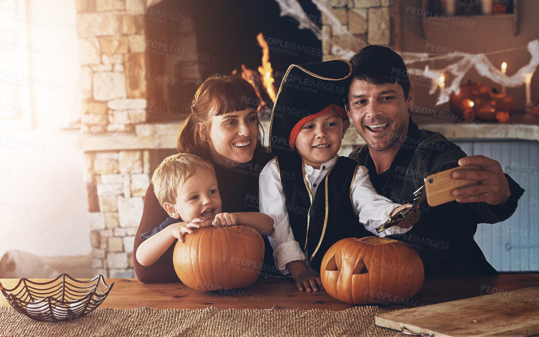 Buy stock photo Parents, children and selfie on halloween in home for happy memory, profile picture update or social media post. Family, people and kids in pirate costume for fantasy, imagination or bonding in house