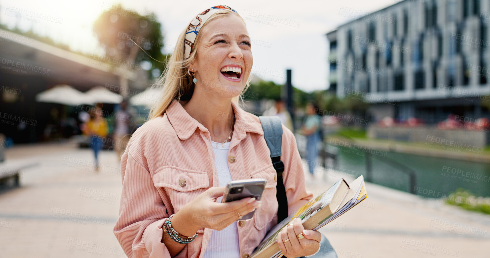 Buy stock photo Laughing, learning and phone with student woman on campus of college or university for education. Books, funny and thinking with happy person outdoor at school for growth, scholarship or study