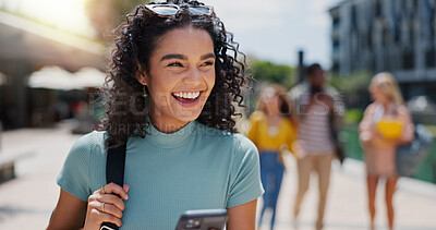 Buy stock photo Education, phone and thinking with student laughing on campus of college or university for learning. Commute, development and funny with happy woman outdoor at school for growth, scholarship or study