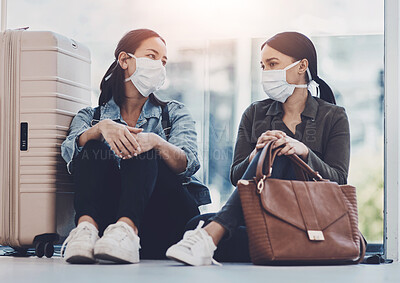 Buy stock photo Women, luggage and mask for virus, travel and health safety with disease prevention regulation in airport. People, pandemic and conversation for flight trip, sick and wellness with suitcase or bag