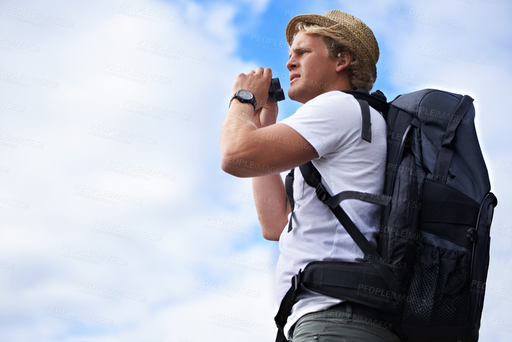 Buy stock photo Man, tourist and binoculars with backpack for hiking, sightseeing or outdoor travel with blue sky background. Male person or young traveler with bag or optical instrument for view, vision or scope