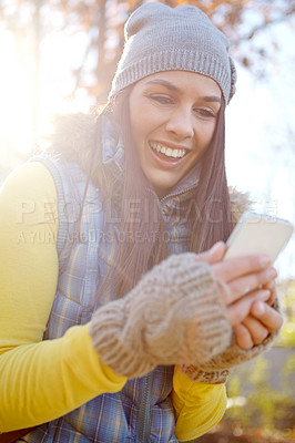 Buy stock photo Woman, smartphone and autumn park or smiling, reading and message on mobile app for communication. happy, internet and online or ecommerce, blog and social media in nature for connection or browse