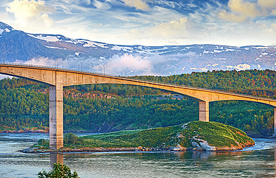 Buy stock photo Bridge, road and outdoor with snow on mountains, nature and trees in forest by water. Landscape, woods and hill with highway, infrastructure and transportation in environment with summer in Norway