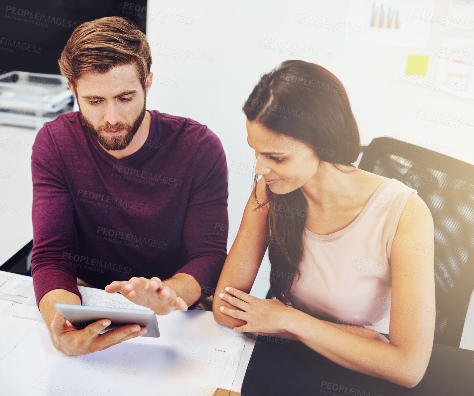 Buy stock photo Cropped shot of two young architects looking at a digital tablet