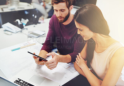 Buy stock photo Cropped shot of two young architects looking at a digital tablet