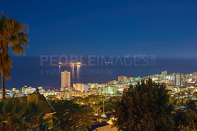 Buy stock photo Night, light and buildings or cityscape and ocean for travel, skyline or urban development. Architecture, skyscraper and hospitality or hotel with horizon or landscape for business and nature or sea