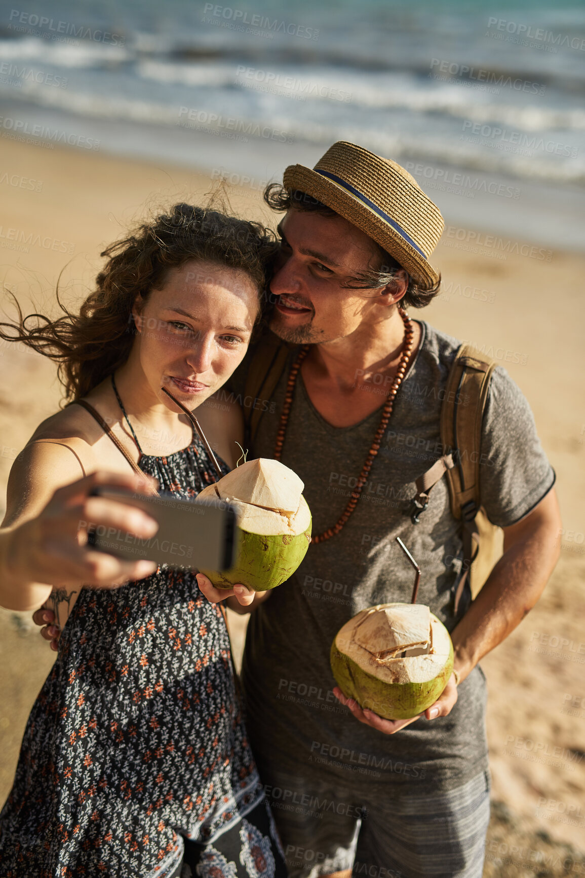 Buy stock photo Selfie, picture and couple with love on beach for social media update, photography and coconut drink for memory. Happy, man and woman travel to tropical ocean together for summer vacation in Spain