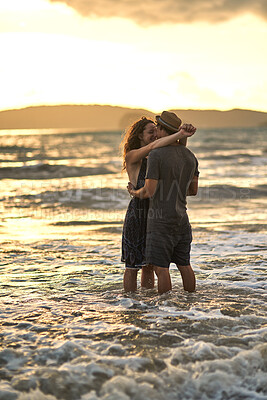 Buy stock photo Sunset, couple and hug in ocean on vacation, support and travel to Bali for tropical lovers at sea. People, embrace and connection in outdoor nature, love and bonding together for holiday in water