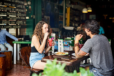 Buy stock photo Restaurant, food and couple for eating on date, hangout and chilling together for bonding with meal. Relationship, boyfriend and girlfriend with beverage, hungry and lunch in Germany for people