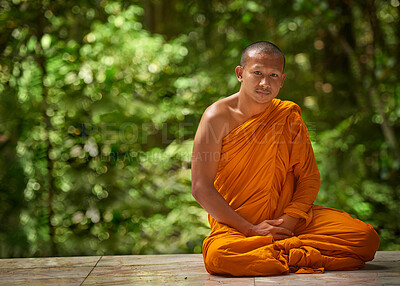 Buy stock photo Calm, man and buddhist monk in portrait on bench for peace, zen and outdoor meditation at shrine. Male person or missionary and prayer pose with orange robe for spirituality, worship and wellness