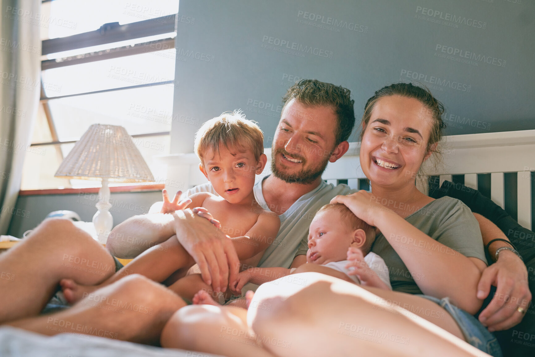 Buy stock photo Family, parents and children in bed of home, relax and weekend in bedroom. Cuddle, support and mother person with father for love and portrait, kid and smile for care and happiness in morning