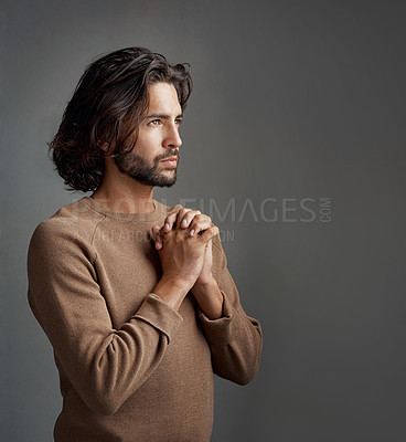 Buy stock photo Gratitude, man and praying with faith, spiritual and person on grey studio background. Believe, model and guy with peace, guidance or wellness with worship, trust or religion with hope or mindfulness