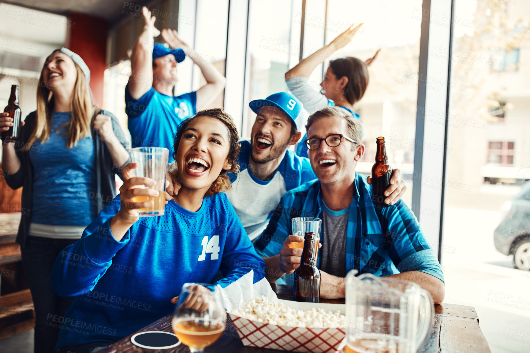 Buy stock photo Friends, celebrate and sports game success, tournament victory and cheering for football league match or pride. Men, woman and team support, fan and winning world cup, score and achievement at pub