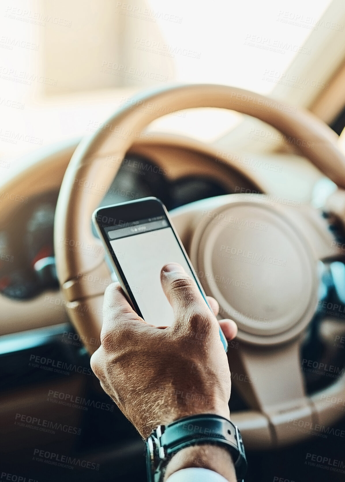 Buy stock photo Cropped shot of an unrecognizable man using a cellphone while driving