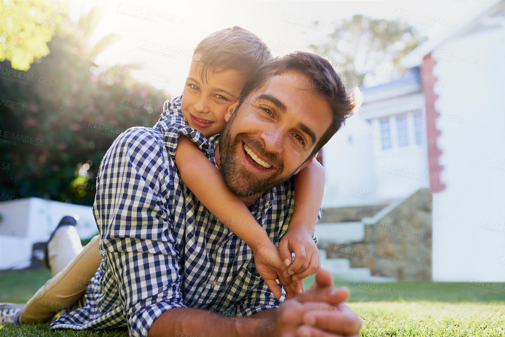 Buy stock photo Father, son and portrait in garden of home with hugging, smile and bonding together on grass. Happy people, dad and child with embrace in backyard of house for playing, relax or parenting outdoor