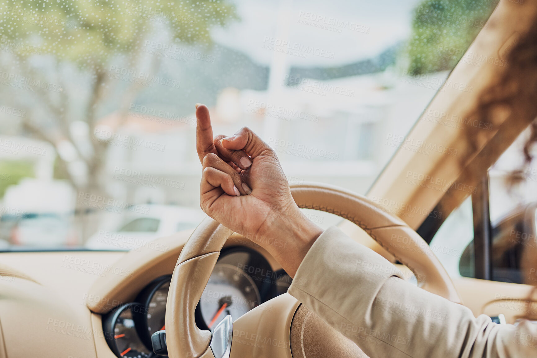 Buy stock photo Shot of an unrecognizable businesswoman showing someone the finger on her morning commute