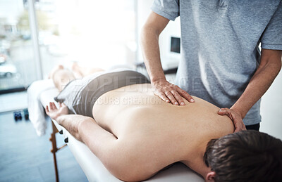 Buy stock photo Hands, back massage and chiropractor working in consulting room, rehabilitation with chiropractic and wellness. People, office and together for physiotherapy service with healthcare or support