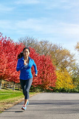 Buy stock photo Asian woman, running and fitness with exercise in nature for cardio workout or outdoor training in countryside. Active female person, athlete or runner for sprint, health and wellness on autumn road