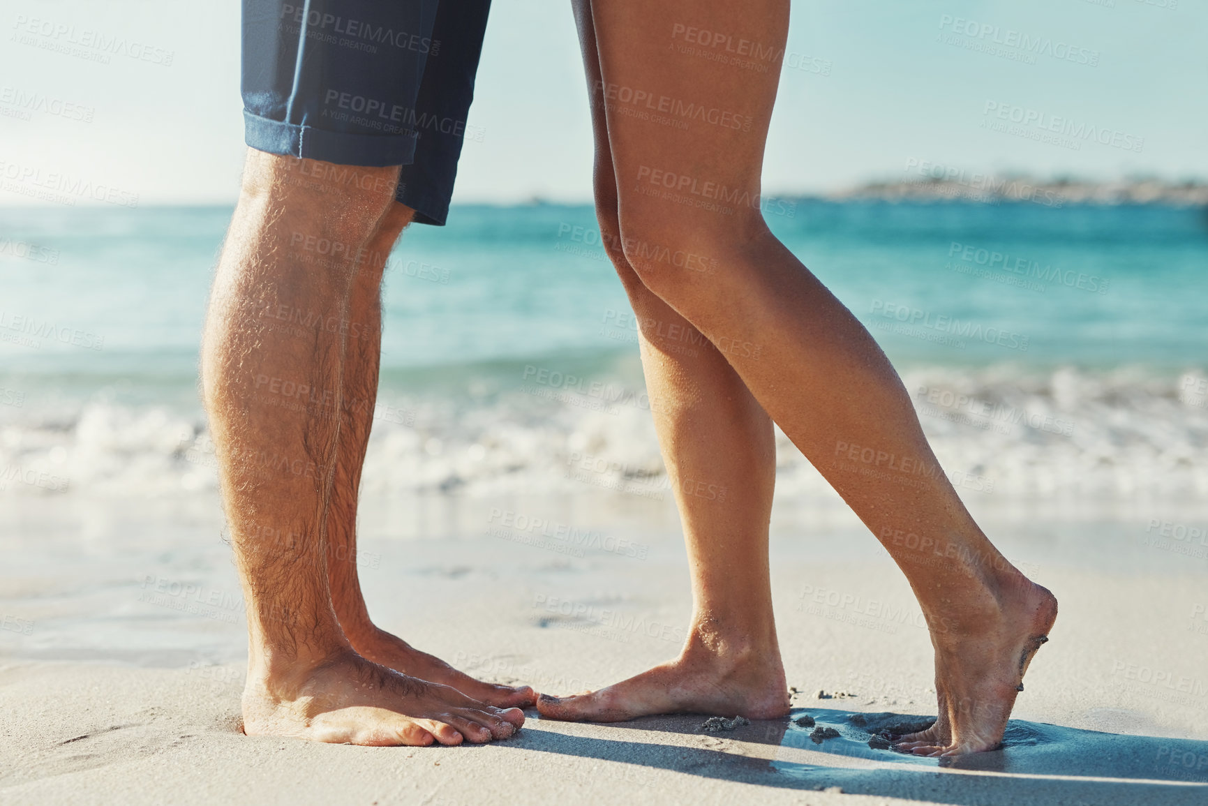 Buy stock photo Legs, people and couple by beach on holiday for love, bonding and care in Miami. Relationship, sand and feet by ocean or seaside for summer vacation, trip and travel for honeymoon and break