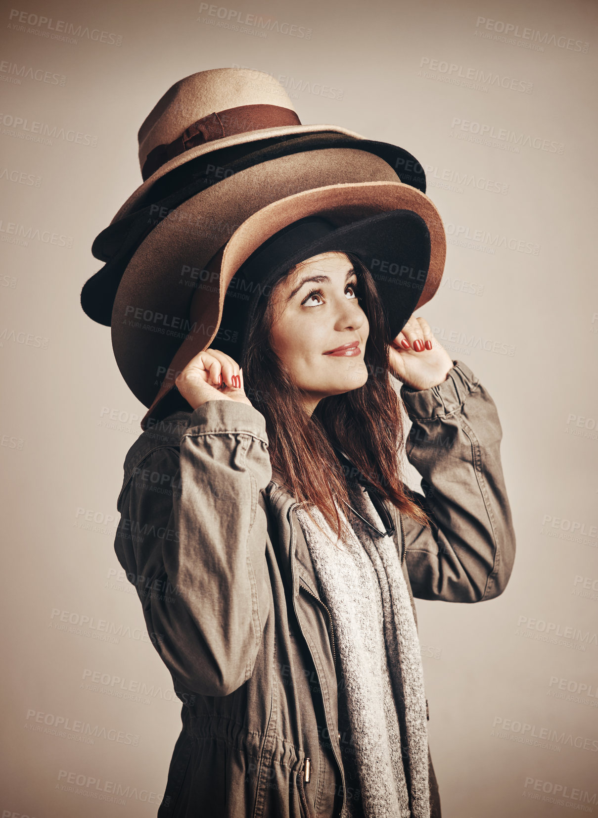 Buy stock photo Fashion, hats and smile with woman in studio isolated on background for style options. Retail, shopping and thinking with happy customer in trendy outfit for accessory decision or clothes purchase