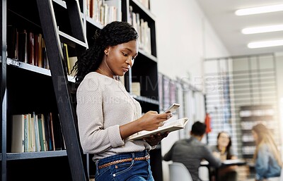 Buy stock photo Black woman, phone and library in school for online information, studying or learning research. Shelf, academy campus or student on mobile app technology for social media, education or website faq