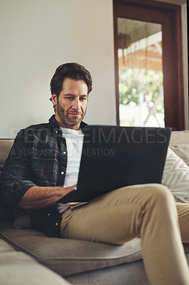 Buy stock photo Man, home and sofa with laptop for remote work or online application for loan. Male person, email and internet with good news or approval for house finance, mortgage and funds in living room