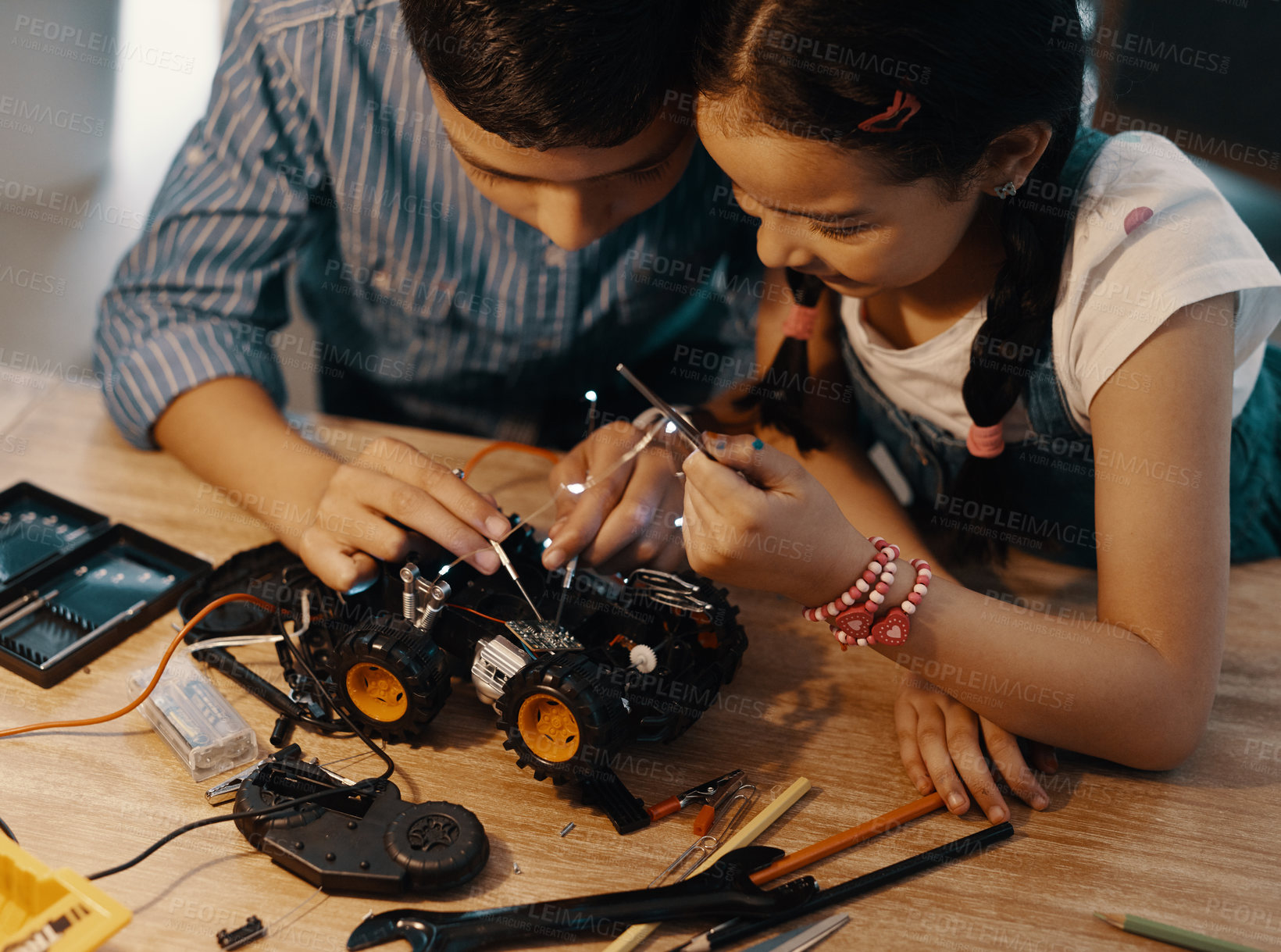 Buy stock photo Kids, tools and car robotics for education with machine learning, developing and study of electronic transport. Boy, girl and vehicle engineering for creative toys, circuit building or trust at house