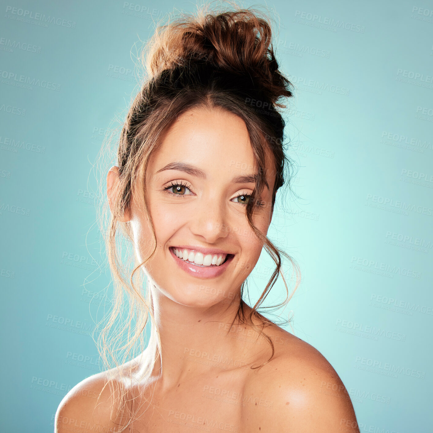 Buy stock photo Happy woman, portrait and hair care in studio with bun for texture, healthy growth or glow on blue background. Female person, trendy curly style and model with beauty aesthetic and keratin results