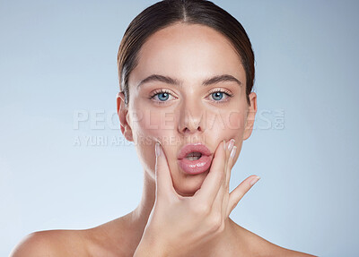 Buy stock photo Portrait, touch and woman with lip filler, studio and hyaluronic acid for plump, mouth and aesthetic. Spa, blue background and glow of skin with dermatology, medical and person proud with results