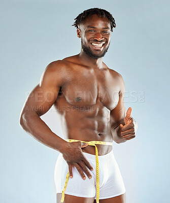 Buy stock photo Weight loss, thumbs up and portrait of black man for fitness, workout and diet success in studio. Transformation, progress or results for exercise with tape and bodybuilder by white background 