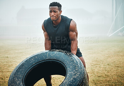 Buy stock photo Nature, fitness and man with tire for workout with strength, muscles and body building training. Sports, fog and African male athlete with equipment for arm exercise with weight challenge in field.