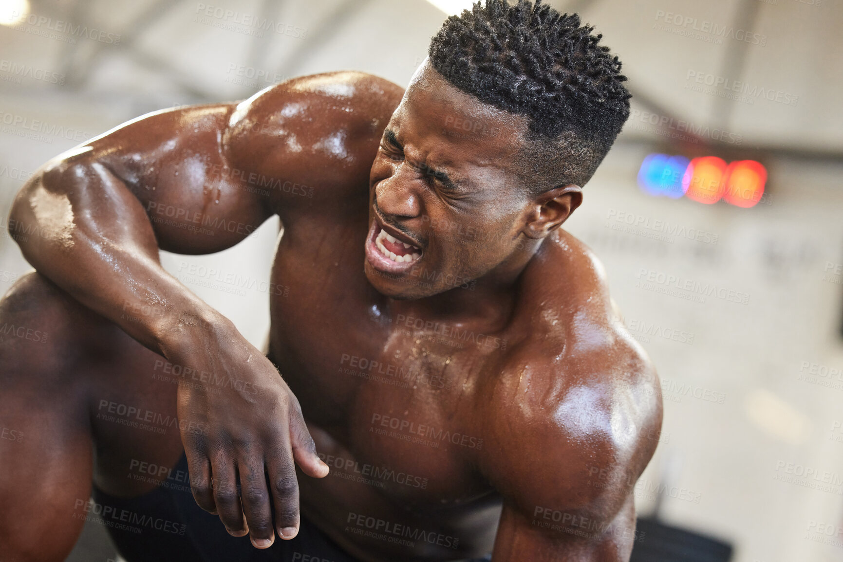 Buy stock photo Exercise, muscle and pain with a black man bodybuilder breathing in the gym, exhausted after a workout. Fitness, injury and sweat with a intense, shirtless male athlete taking a break from training