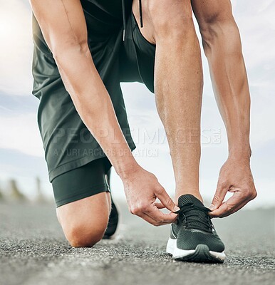 Buy stock photo Male athlete, outdoor and ready with shoe laces for sports, exercise and fitness training on road. Healthy man, safety and workout routine for action, wellness and strong muscle in practice or warmup