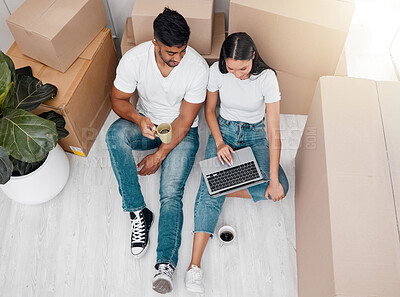 Buy stock photo Couple, laptop and boxes in home with coffee for moving, packing or real estate shopping and property search. Above, man and woman with technology for internet research and realtor communication